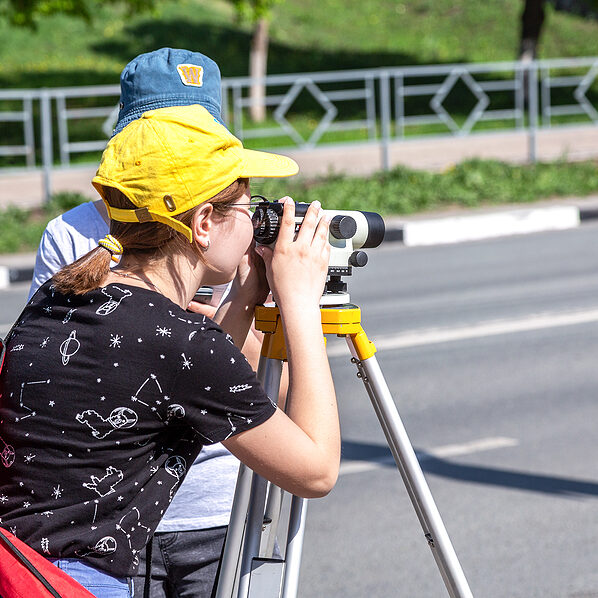 Samara, Russia - June 12, 2019: Surveyor engineer worker making measuring with geodetic optical level.Topographic survey. Geodetic works